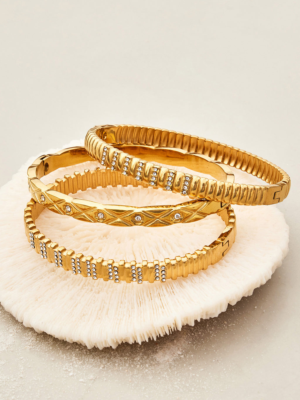 Elara gold bangle with X-motifs and tiny stones, 316L stainless steel — Crown Crest Jewel