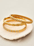 Elara gold bangle with X-motifs and tiny stones, 316L stainless steel — Crown Crest Jewel