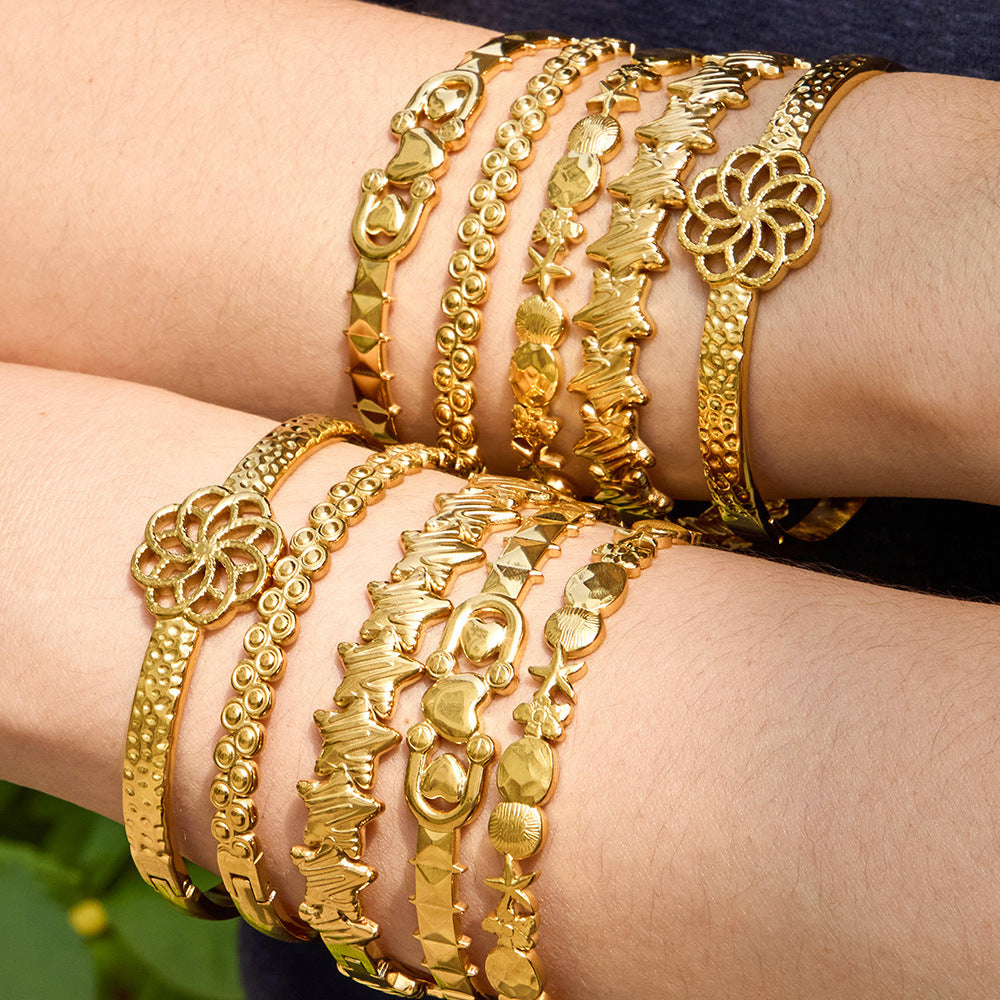 Halo sculptural gold bangle of interlocking circles, 316L stainless steel — Crown Crest Jewel