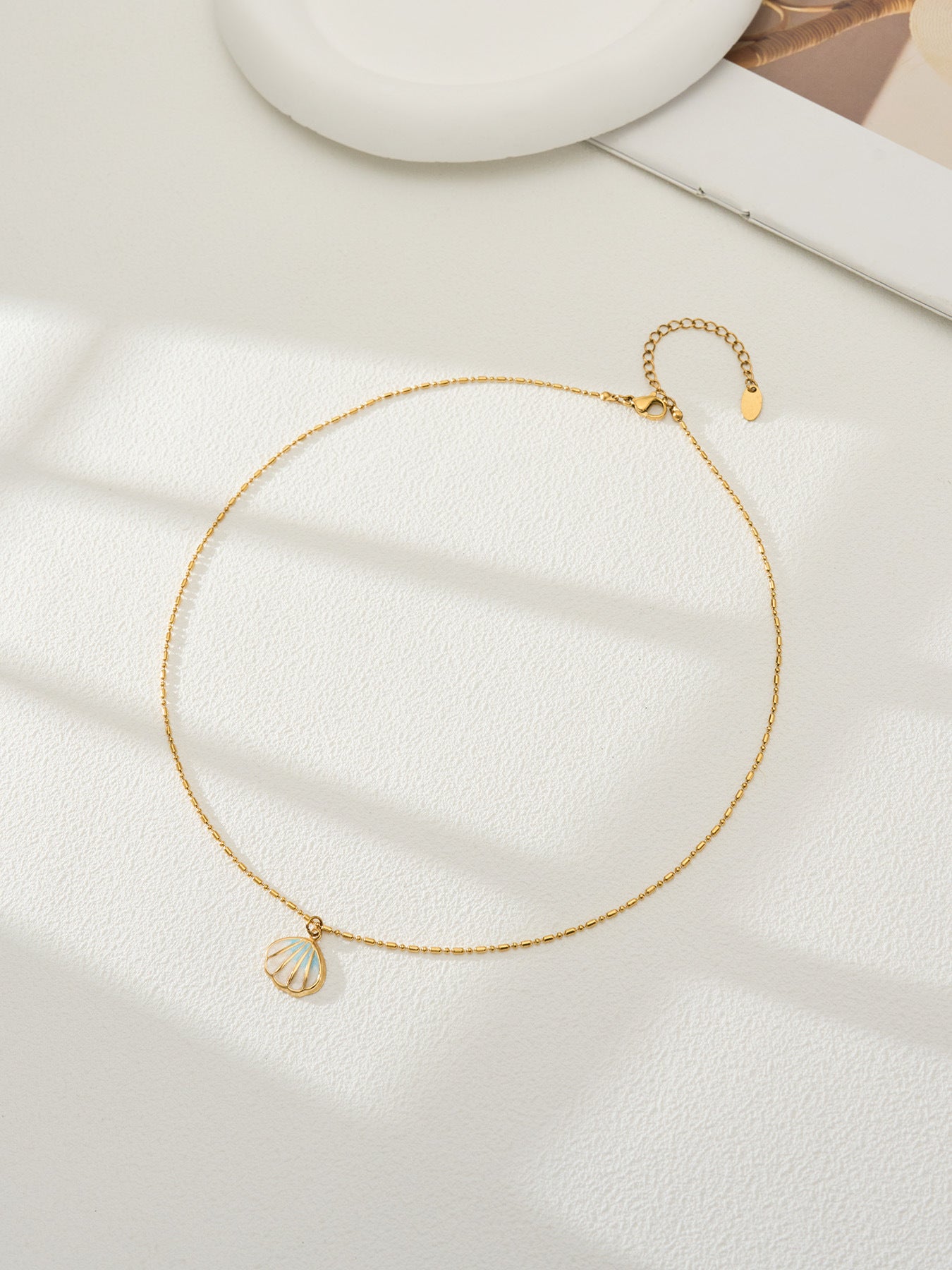Chaza gold necklace with a coastal shell-inspired pendant, 316L stainless steel — Crown Crest Jewel