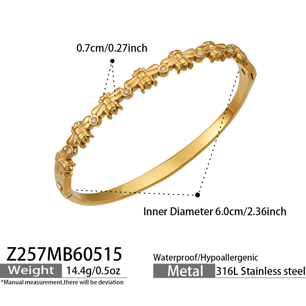 Aste slender gold bangle with sculptural stone detail, 316L stainless steel — Crown Crest Jewel