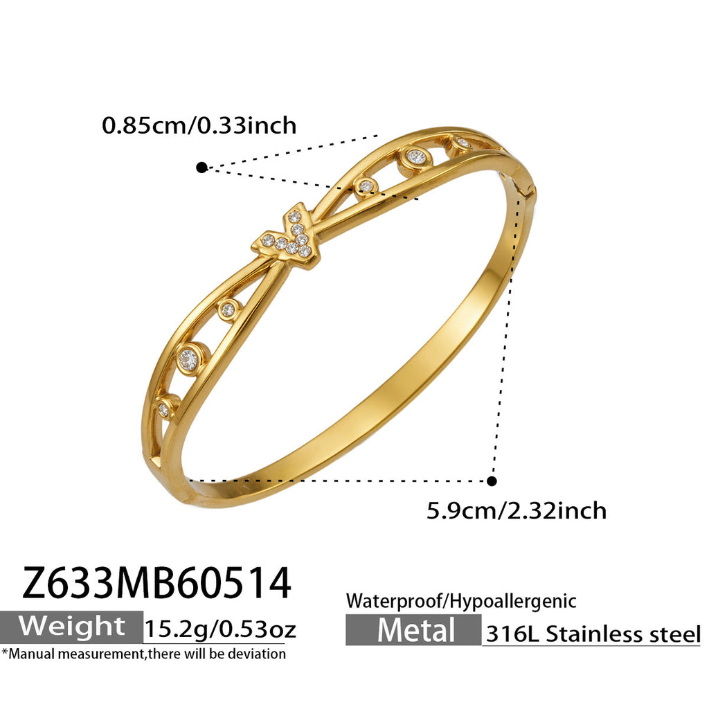 Avielle gold bangle with crossed bands and stone-set V centre, 316L stainless steel — Crown Crest Jewel